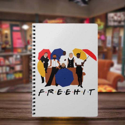 Notebook with colorful illustrations of people holding umbrellas and the word 'FREEHIT' on a blurred background.