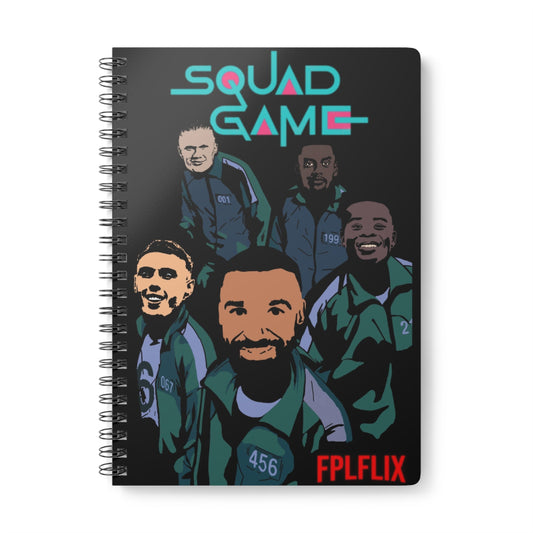 Notebook with illustrations of people and 'Squad Game' text on a black background