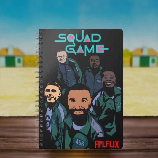 Notebook with 'Squad Game' design featuring illustrations of people on a blurred background