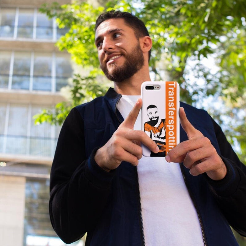 Man holding a phone with a Transferspotit case outdoors