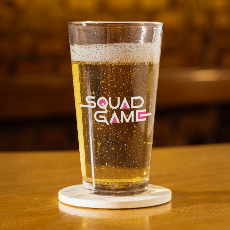 pint glass full of beer with logo on front
