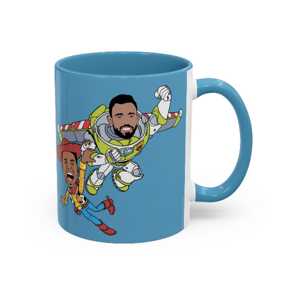 Blue mug with cartoon design of a person in a spacesuit and another character on a white background