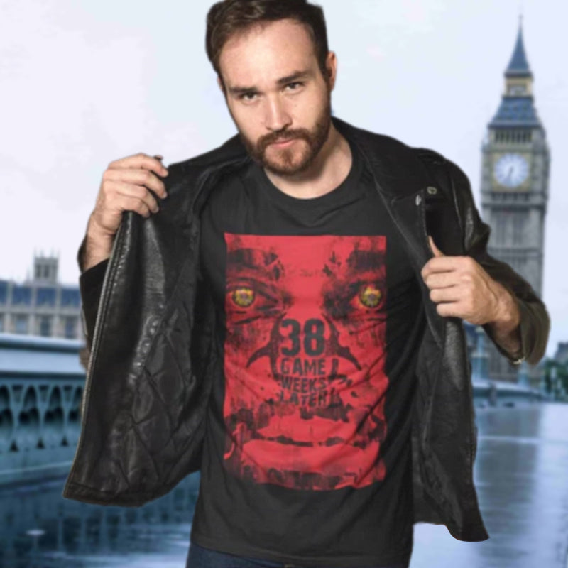 Man wearing a black t-shirt with a red graphic design in front of a blurred cityscape with a clock tower.