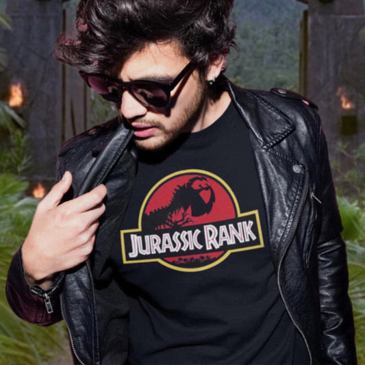 Person wearing a black t-shirt with 'Jurassic Rank' design, standing outdoors.