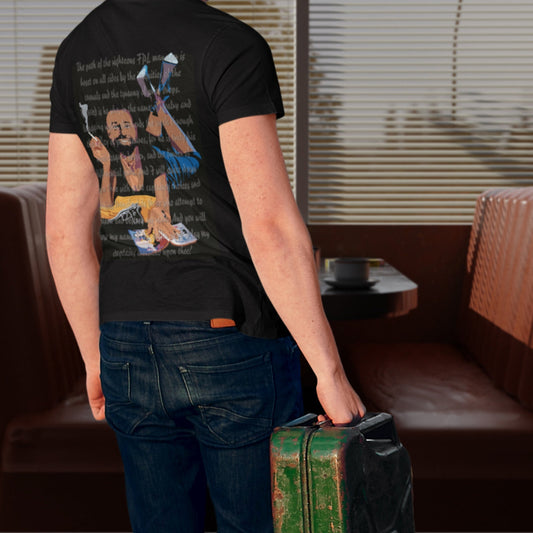 Person wearing a black t-shirt with a graphic design, standing in a room with brown leather chairs.