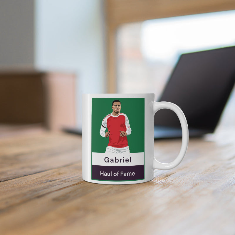 Mug with a sports-themed design featuring a player in a red jersey on a wooden surface.