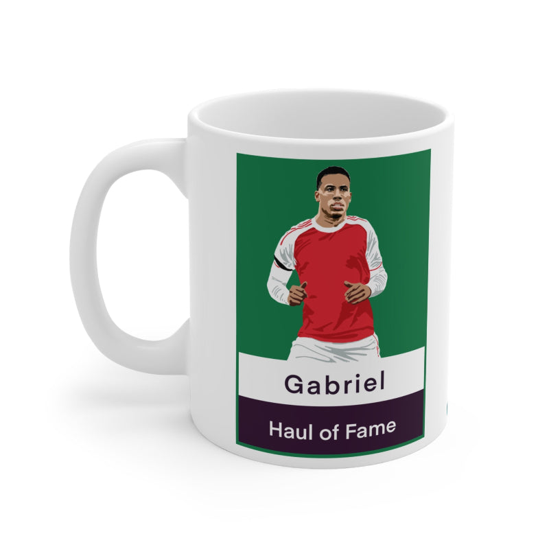 Mug with a graphic of a person wearing a red sports jersey on a green background, with text 'Gabriel Haul of Fame'.