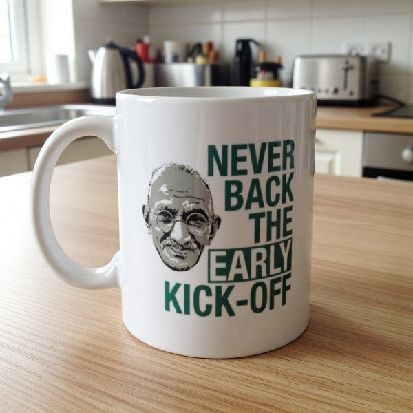 White mug with Gandhi illustration and text on a kitchen counter