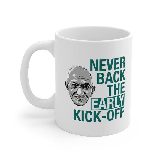 A white ceramic mug with a handle, featuring a graphic print of a stylized portrait of Muhammad Ali next to the text 'NEVER BACK THE EARLY KICK-OFF' in dark teal lettering.