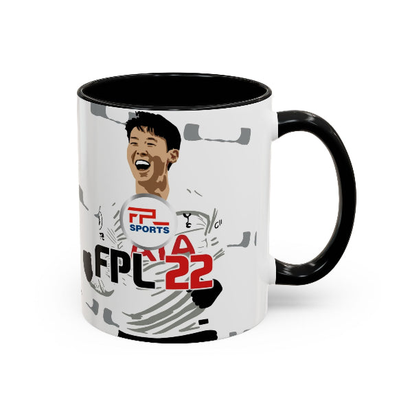 A ceramic mug with a black handle and interior, featuring a printed graphic of a smiling soccer player in a white jersey with 'FPL SPORTS' and 'FPL NA 22' text on a white background.