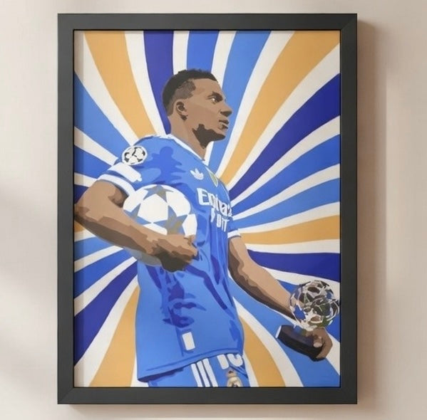 Framed artwork of a soccer player holding a trophy against a sunburst background