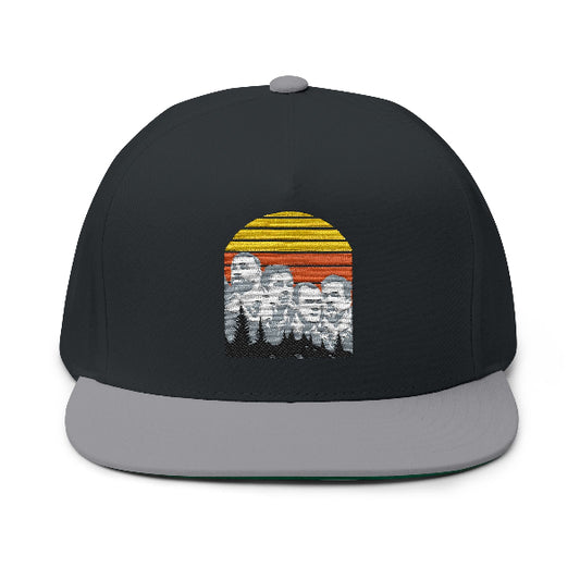 A black snapback cap with a gray flat brim, featuring a front graphic of a retro sunset with yellow and orange stripes behind a pixelated portrait of four men.