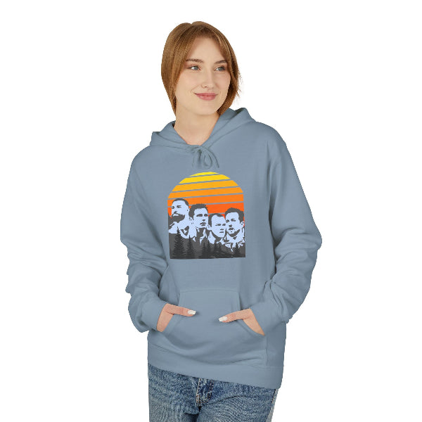 A woman wearing a dusty blue hoodie with a vintage-style graphic of the band Nirvana on the front, set against a plain white background.