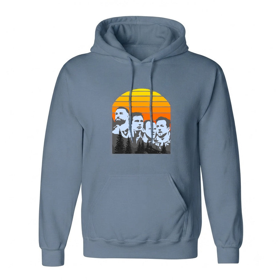 A slate blue pullover hoodie with a front kangaroo pocket and a graphic print of four men's faces in black and white set against a retro orange and yellow sunset on the chest.