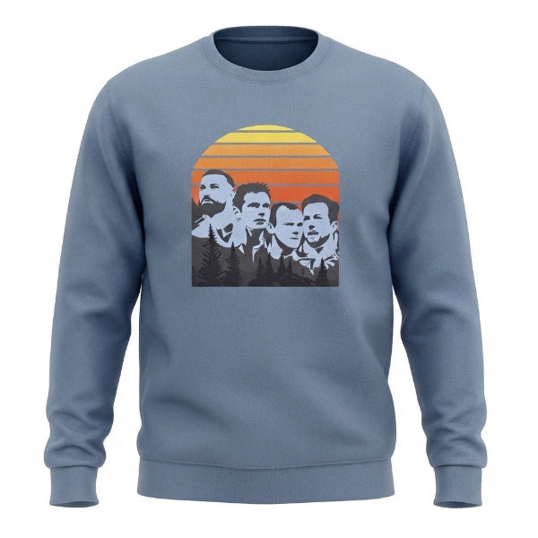 A dusty blue crewneck sweatshirt featuring a retro-style graphic print of four men's faces in black and white, set against a yellow, orange, and red sunset background.