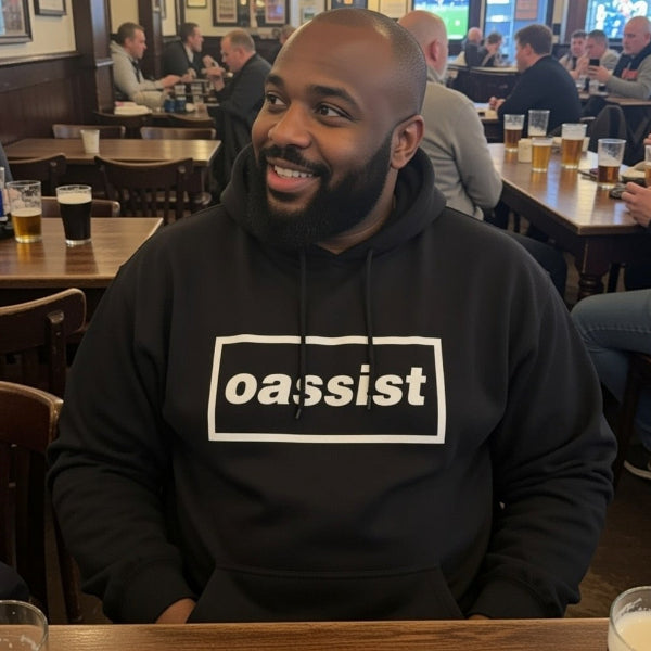 Man wearing a black hoodie with 'oassist' logo in a pub setting
