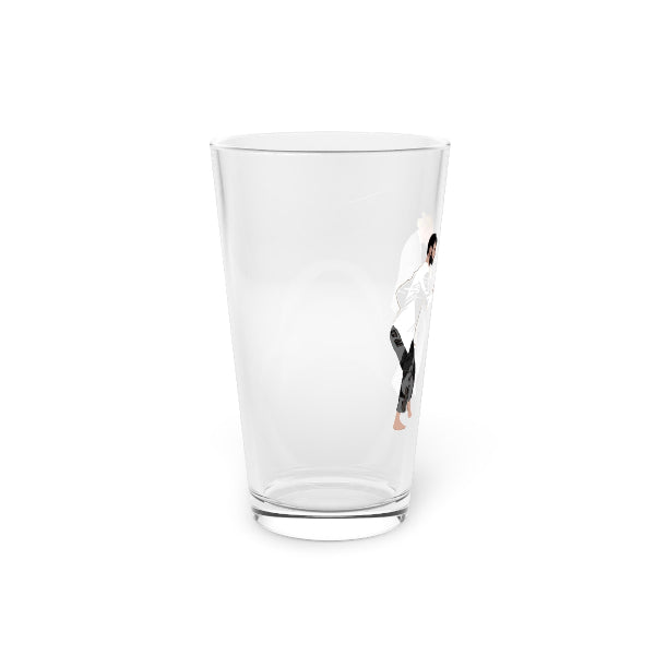 Clear glass tumbler with a small figurine inside on a white background
