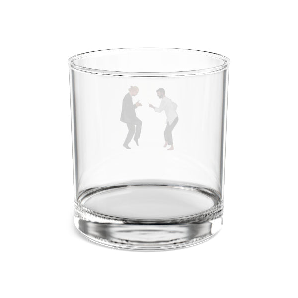 Clear glass tumbler with engraved figures on a white background