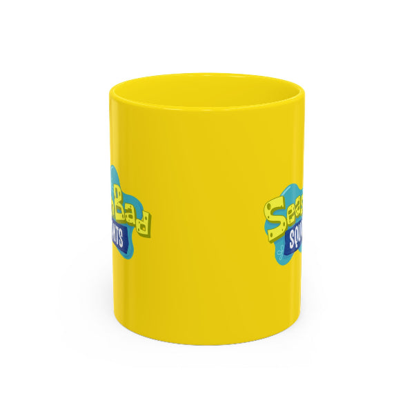 Yellow mug with blue and green text on a white background