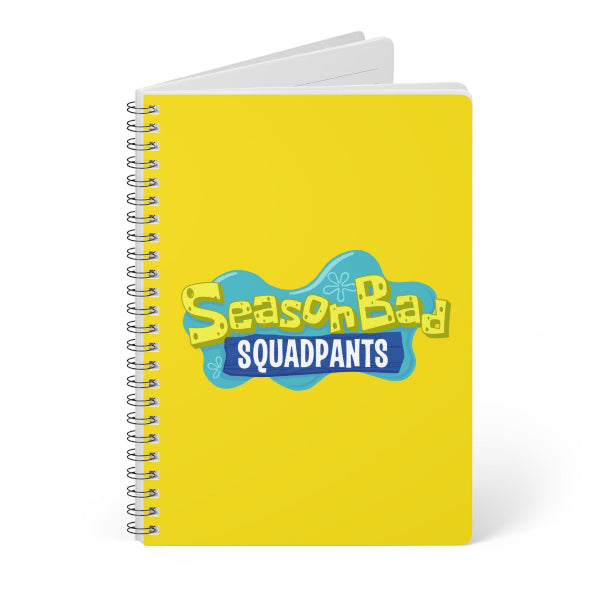 Notebook with 'SeasonBad Squadpants' design on a yellow background