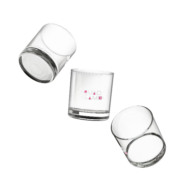 Set of four clear glass tumblers with gold geometric patterns on a white background