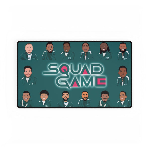 A rectangular desk mat featuring an illustration of characters from the TV show 'Squid Game' on a dark teal background. The mat includes 16 stylized character portraits arranged around the central title 'SQUAD GAME' in a glowing font.
