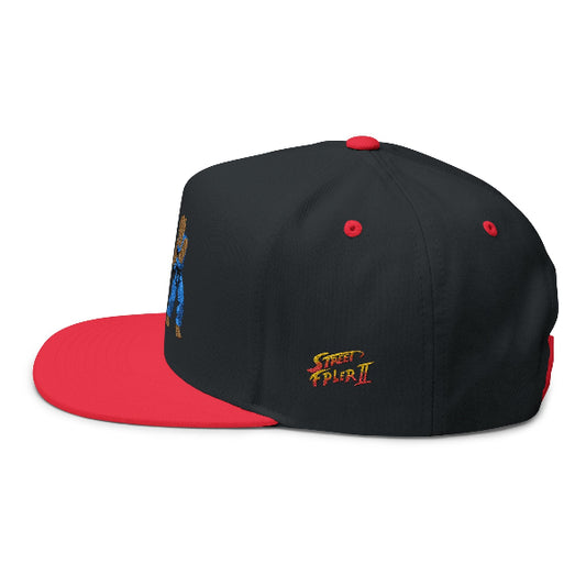 A black and red snapback cap featuring a colorful graphic on the side and a gold and red embroidered 'Street Fighter II' logo on the front, shown against a plain white background.