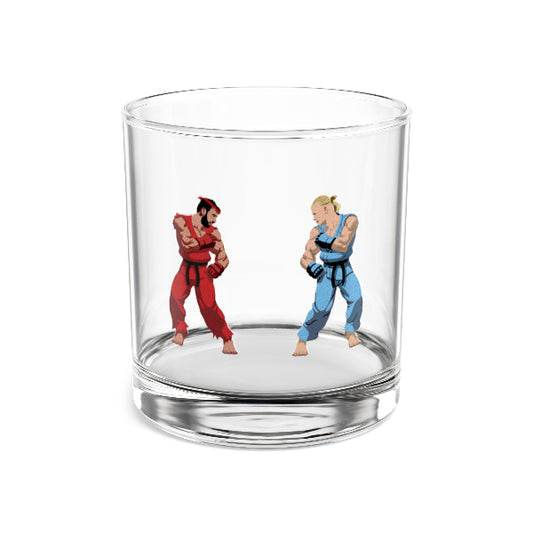 Clear glass tumbler with two figurines, one in red and the other in blue, on a white background.