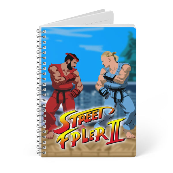 Notebook with 'Street Fighter II' cover featuring two characters in a fighting stance.