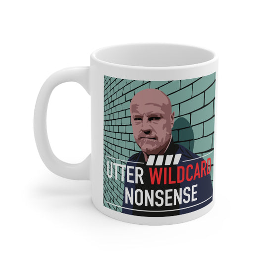 A white ceramic mug featuring a satirical graphic print of a bald man in a suit against a teal brick wall, with the text 'UTTER WILDCARD NONSENSE' in white and red.