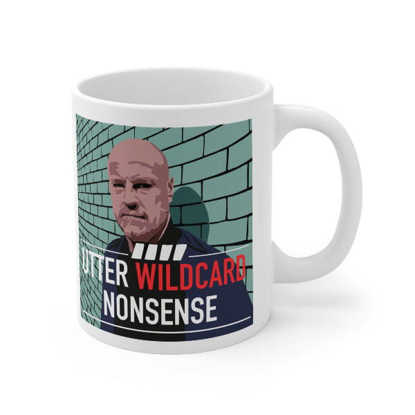 A white ceramic mug featuring a printed graphic of a bald man's portrait against a teal brick wall, with bold text reading 'UTTER WILDCARD NONSENSE' in red and white.